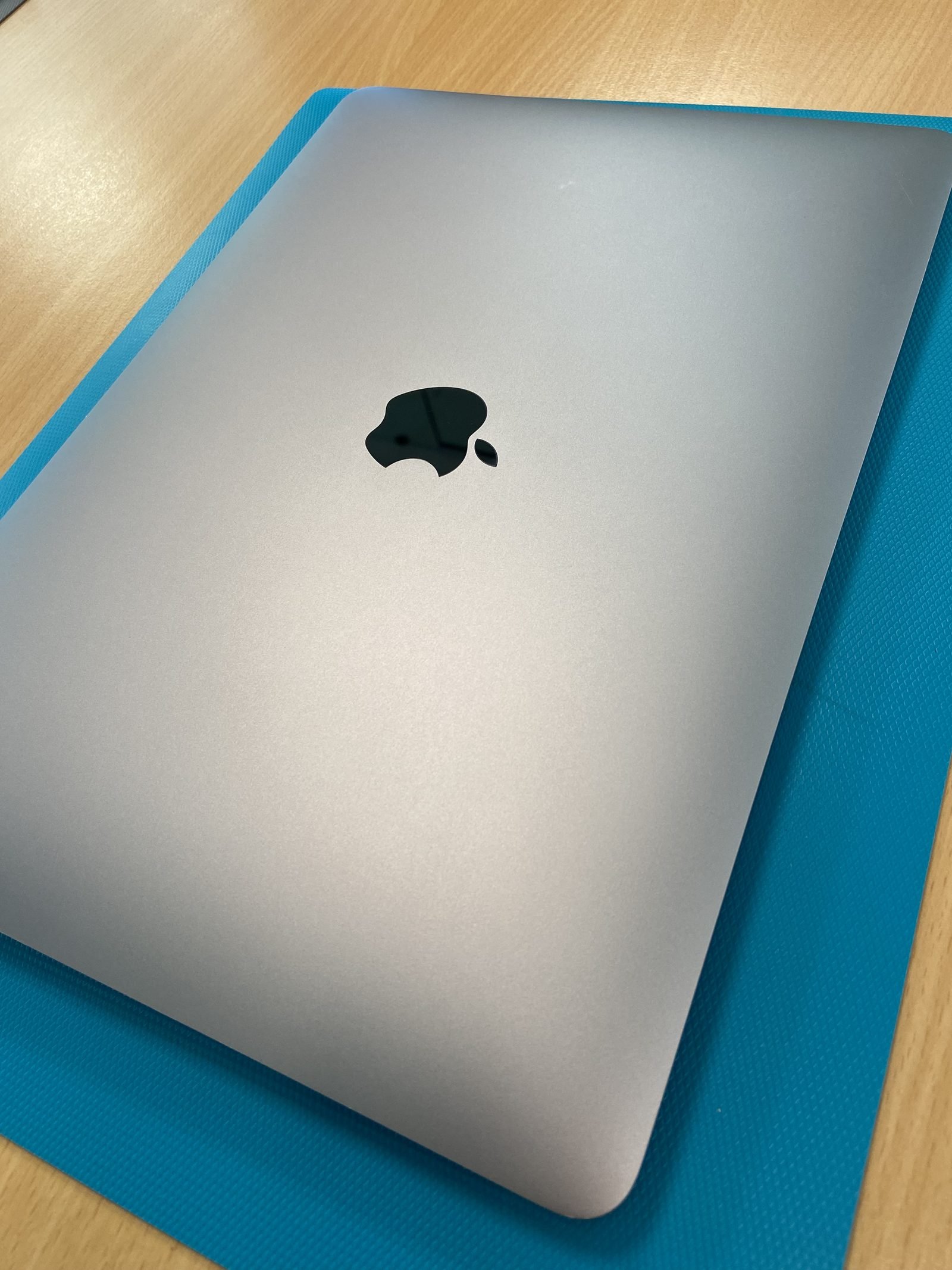 MacBook Air open lid on a repair bench in Dubai Media City workshop
